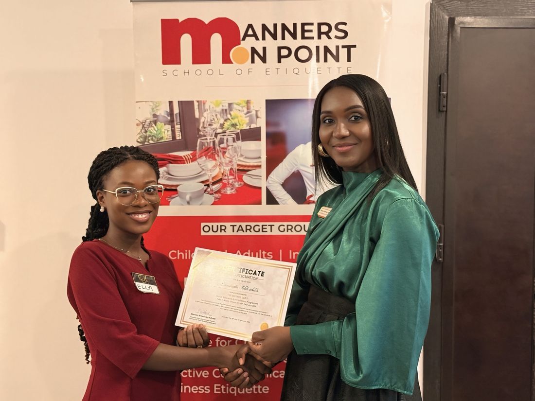 A participant receiving her Certificate of Participation for The Refined Lady.